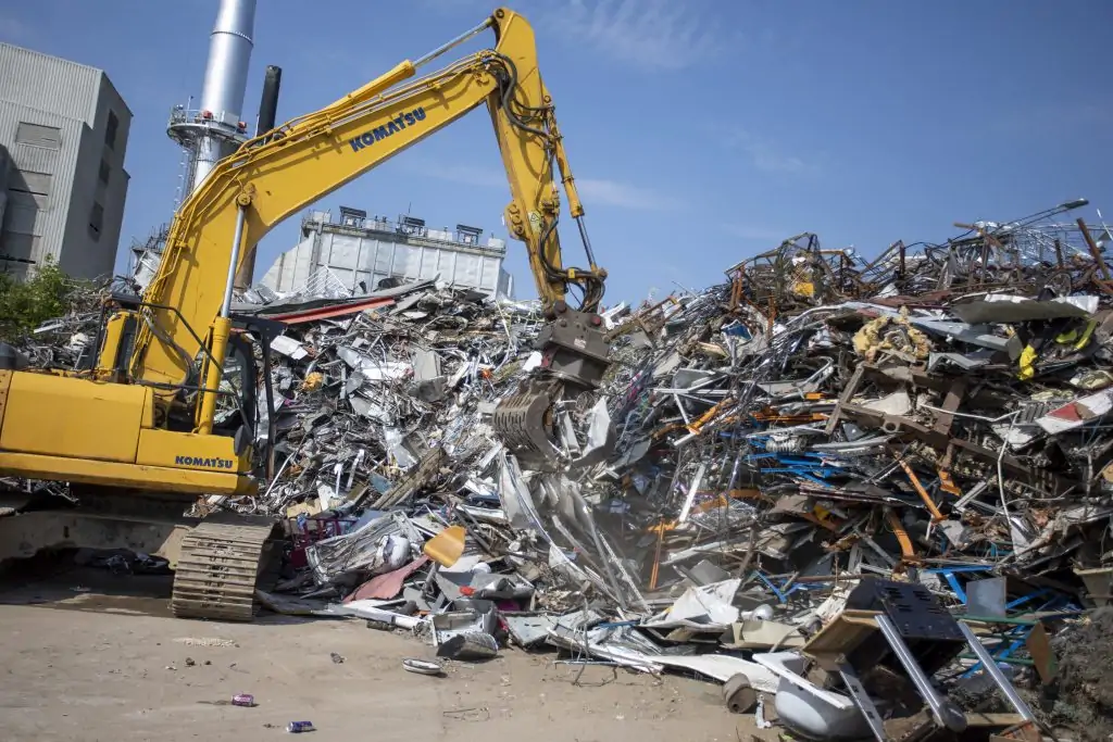 a digger picking up scrap metal